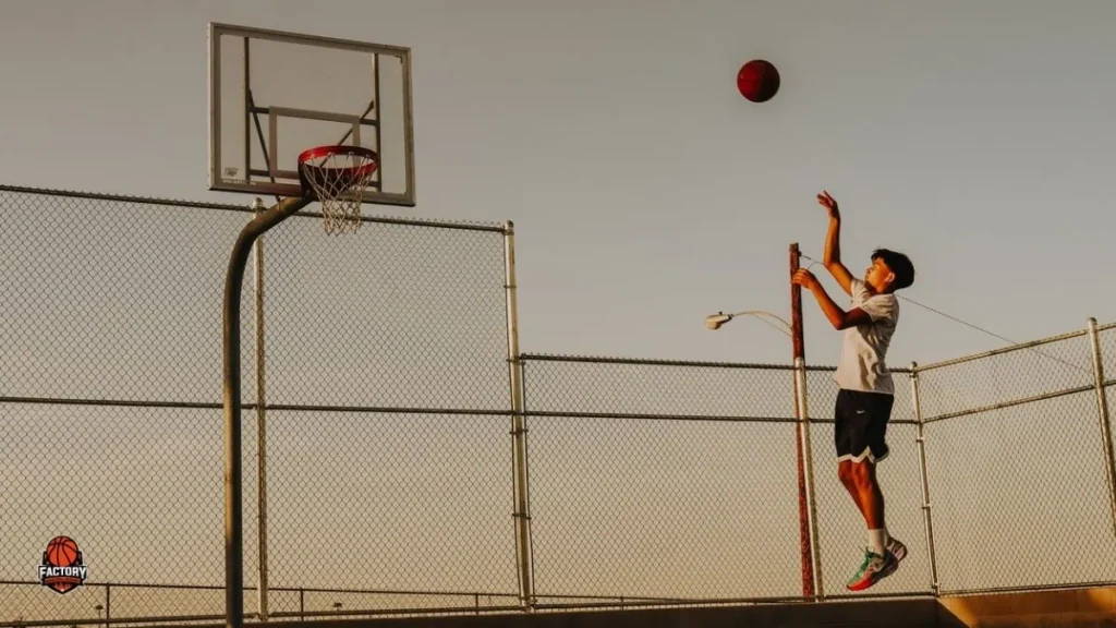 Youth basketball player practising shooting form